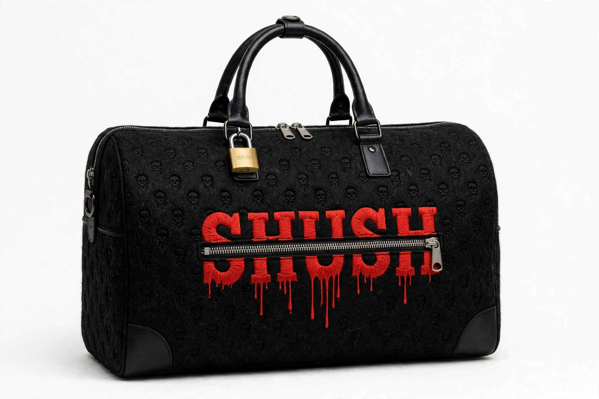 SHUSH duffle bag in black felted wool with tone-on-tone skulls — the name SHUSH embroidered in red dripping letters across a real zipper, brass SHUSH padlock at the handles