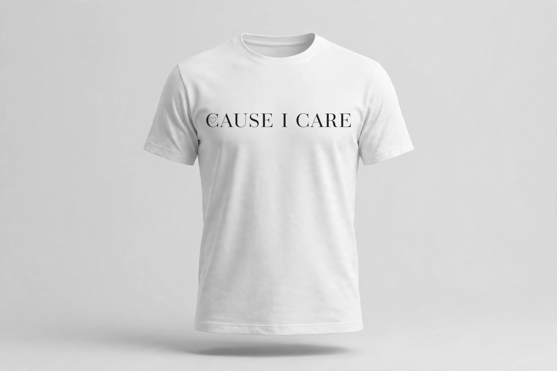 White T-shirt with a black serif Cause I Care chest print, the C drawn with a fine heart outline