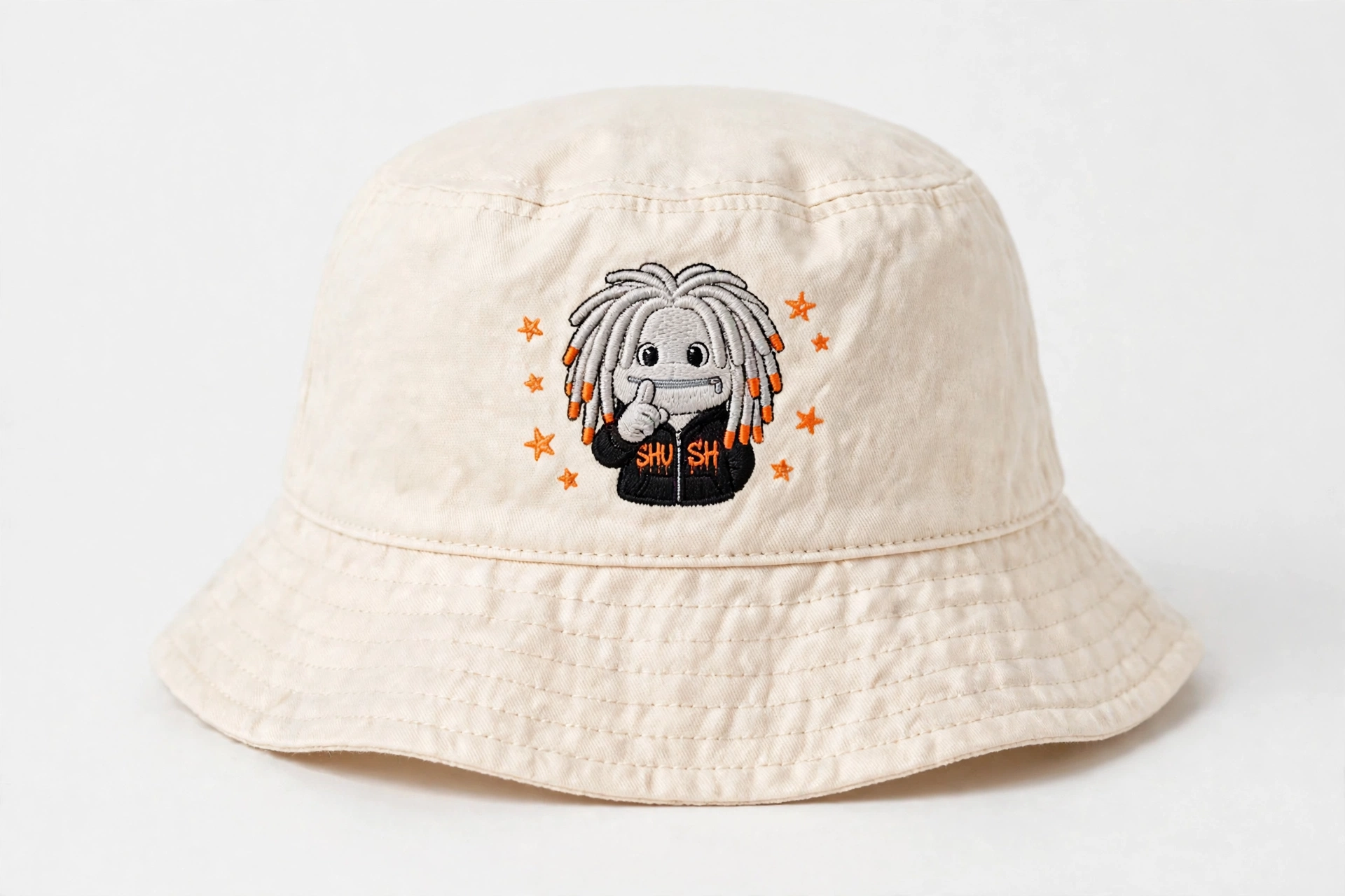 SHUSH kids bucket hat in Cream — the light-gray friend and orange stars embroidered in thread on the front, nothing glued on